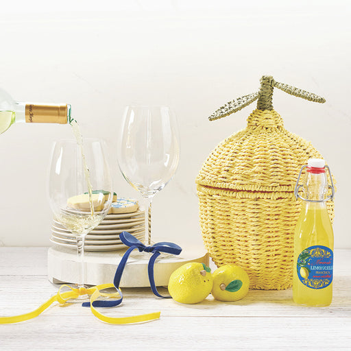 lemon wicker basket styled with wine glasses lemons and summer table decor
