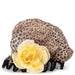 A leopard print shower cap with a large cream flower and black binding.