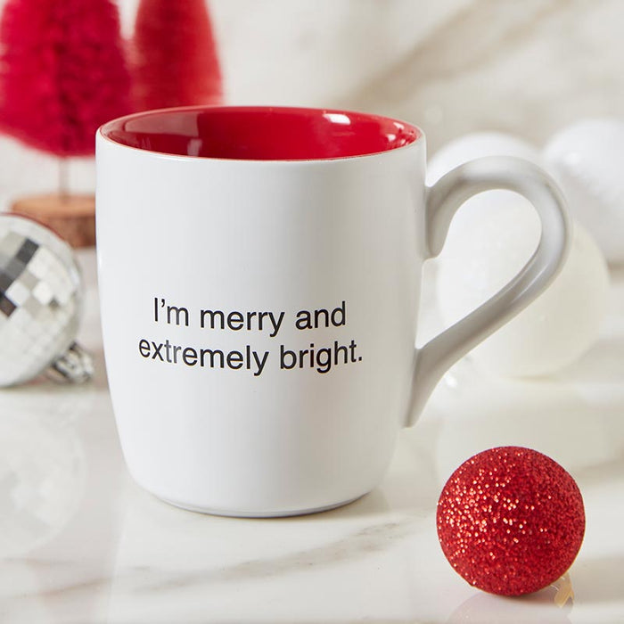 White ceramic Christmas mug with red interior reading I'm merry and extremely bright