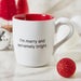 White ceramic Christmas mug with red interior reading I'm merry and extremely bright
