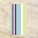 multi-color striped guest paper towels with clean vertical stripes displayed in a clear holder, colorful napkins for entertaining or bathroom use