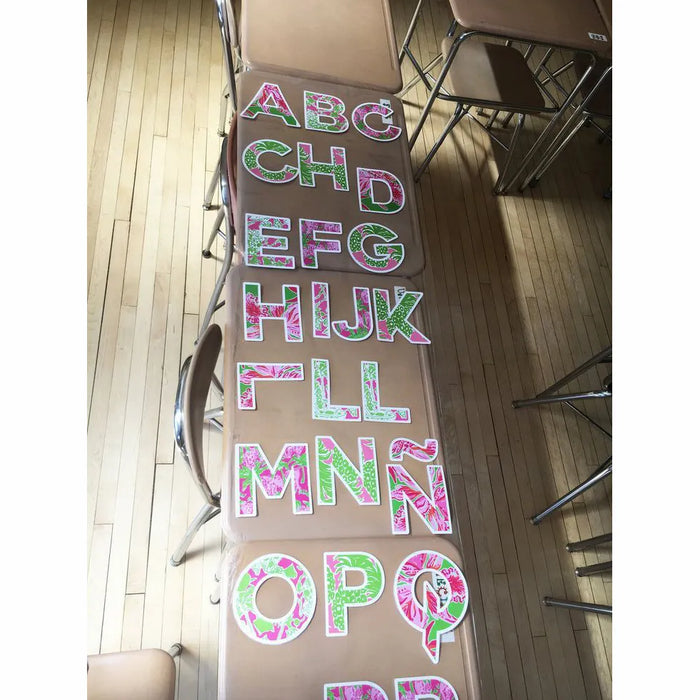 Palm beach alphabet banner printable letters A to Z displayed on wall in colorful pink and green