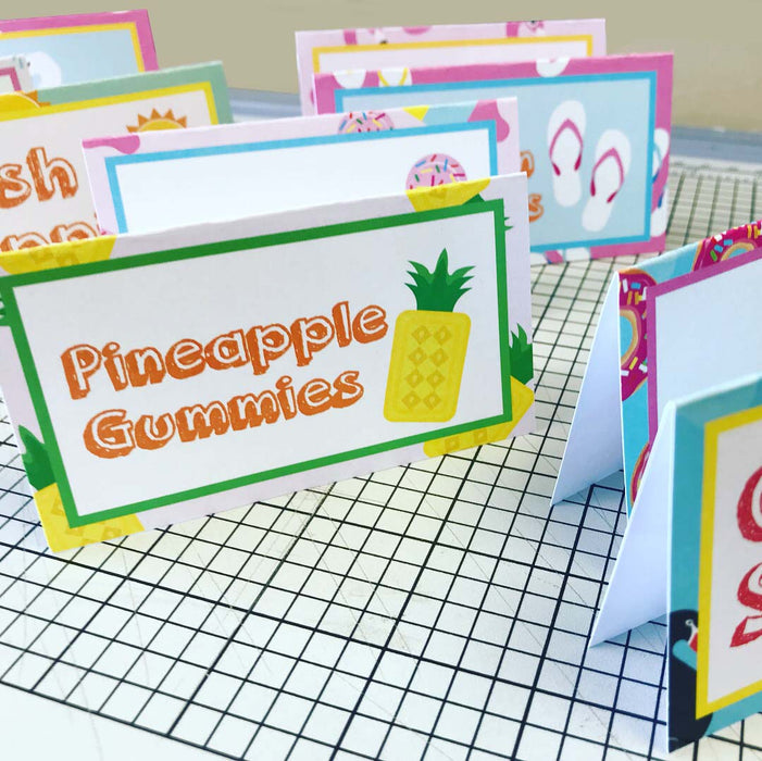 Pool floaty food tent with pineapple gummies label and tropical design