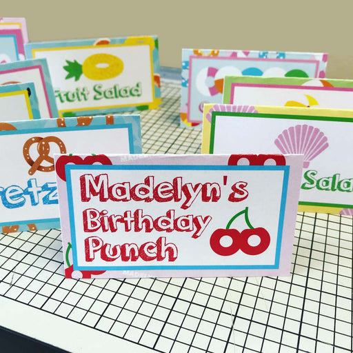 Personalized pool floaty food tents with custom birthday punch and fruit salad labels
