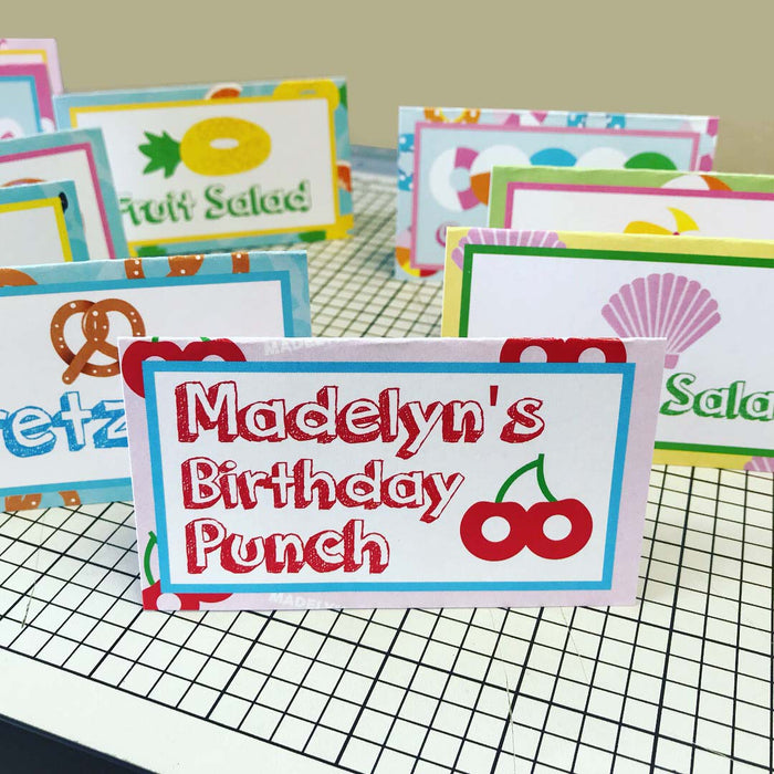 Personalized pool floaty food tents with custom birthday punch and fruit salad labels