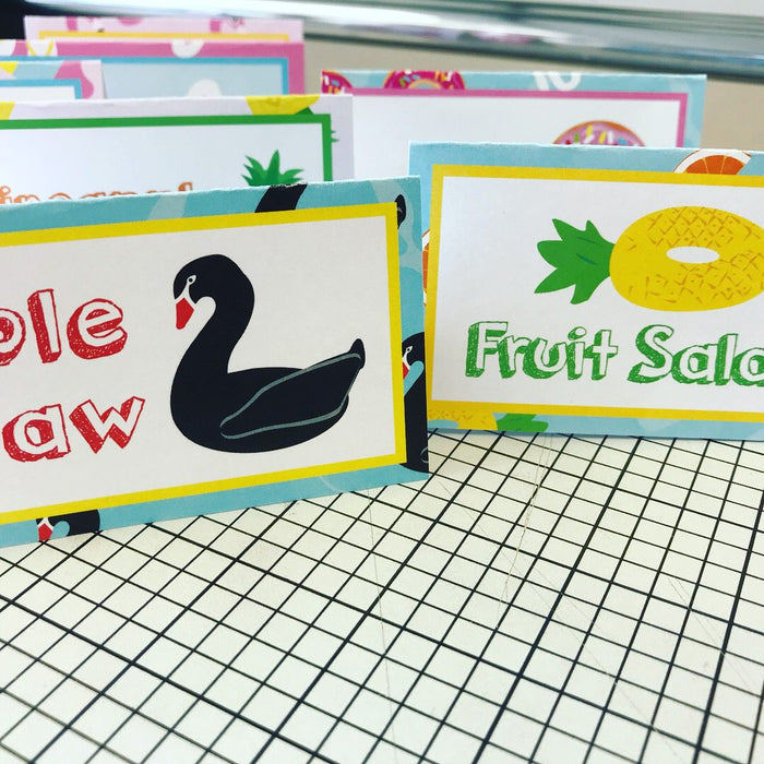 Colorful pool floaty food tents with swan and fruit salad designs