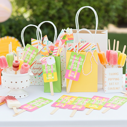 Custom popsicle gift tags in goodie bags at outdoor summer party — personalized thank you tags