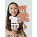 Girl holding preppy plaid baby shower printable photo booth props including teddy bear and onesie