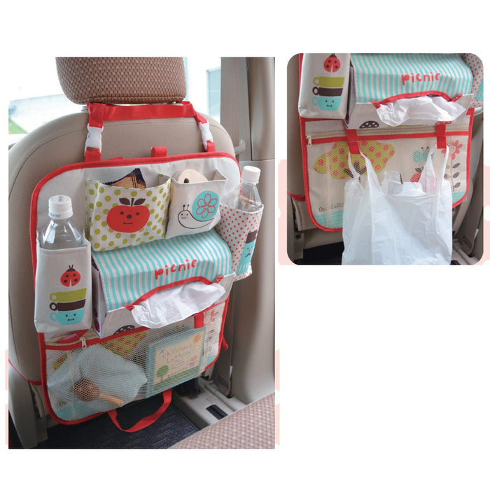 Red polka dot backseat car organizer laid flat showing 6 compartments including insulated bottle pockets, zipper pocket, and tissue holder — made in Japan