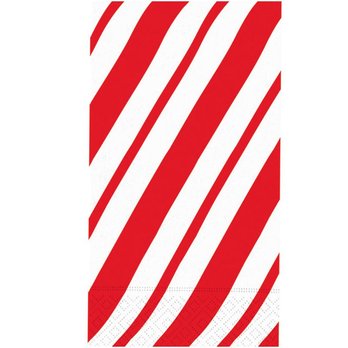 red and white striped guest paper towels with bold diagonal stripes displayed in a clear holder, candy cane inspired napkins for holiday entertaining