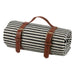 Striped Picnic Blanket — rolled black and white stripe acrylic blanket with tan leather carry straps and buckles, PEVA waterproof backing
