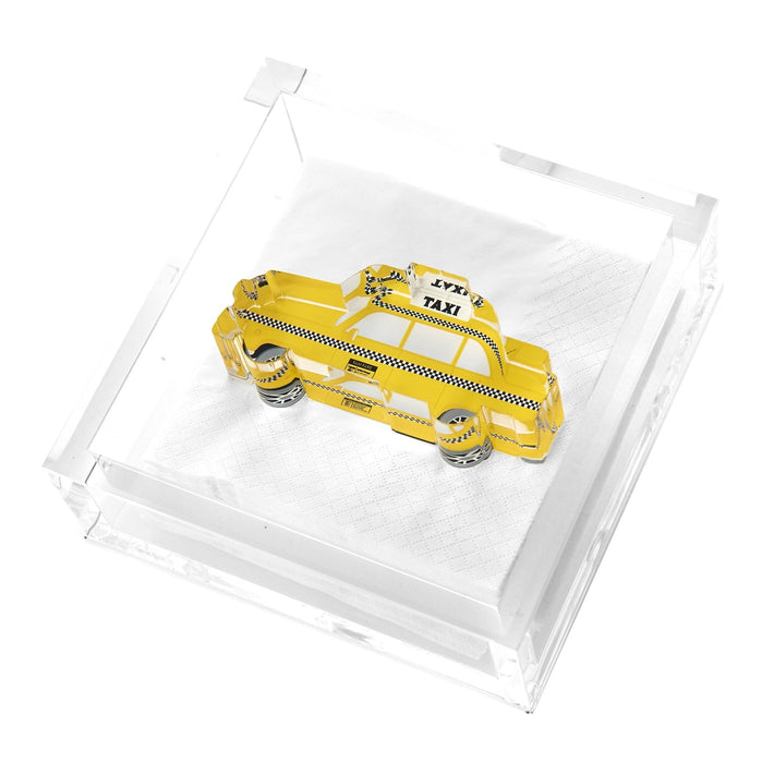 Clear acrylic cocktail napkin holder with yellow New York City taxi cab weight and white napkins