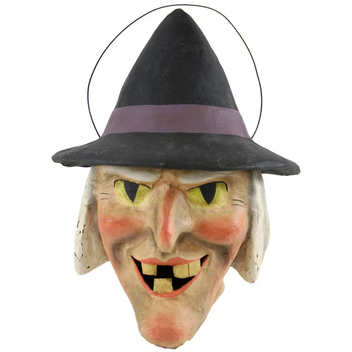 Vintage-inspired witch candy bucket with black hat, wire handle, and hand-painted paper mache face for Halloween decorating or trick-or-treat displays.