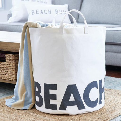 Large white canvas beach storage tote with BEACH lettering and waterproof laminated lining