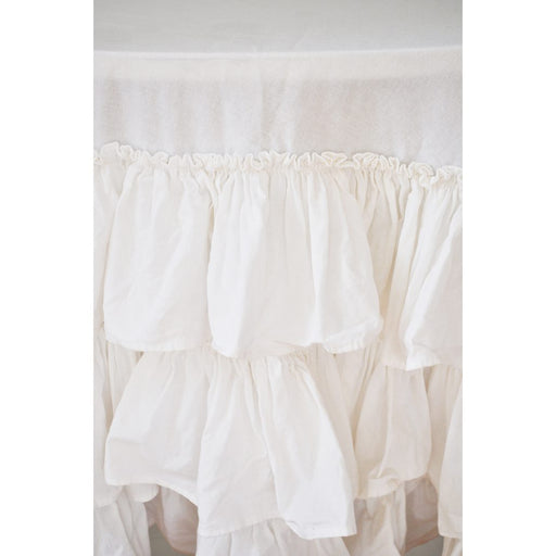 Close-up of white cotton ruffle layers on round tablecloth