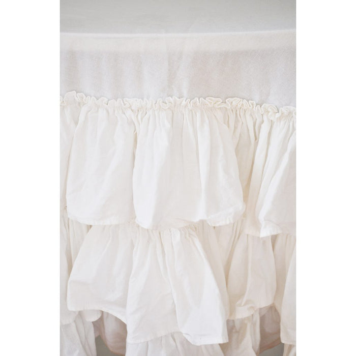Close-up of white cotton ruffle layers on round tablecloth