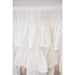 Close-up of white cotton ruffle layers on round tablecloth