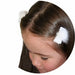 white fur ball velvet hair clip on a young girl's hair