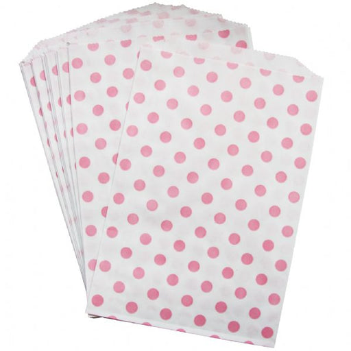 A set of white paper treat bags with pink polka dots.