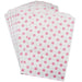 A set of white paper treat bags with pink polka dots.