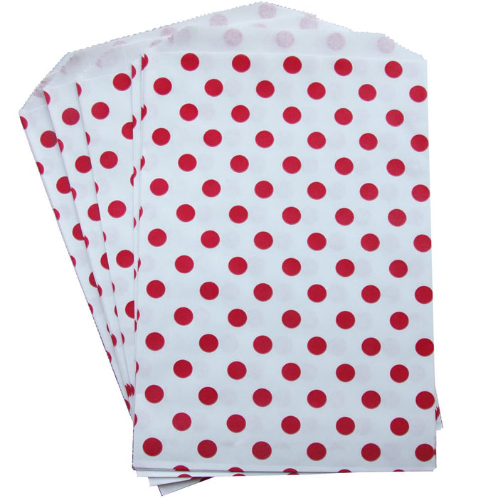 A set of 20 white treat bags with red polka dots.