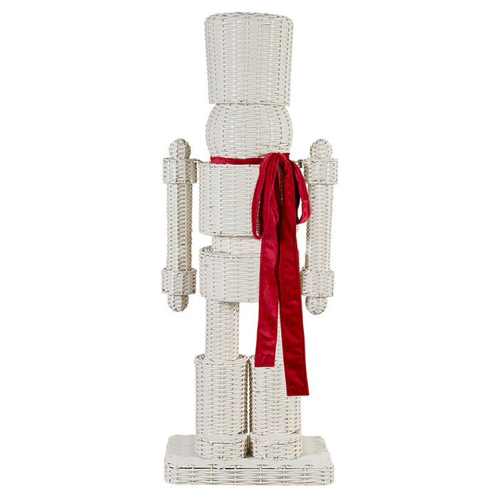 Decorative wicker nutcracker with a red ribbon on a white background