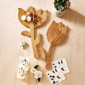 Handcrafted mango wood tulip-shaped cutting board with a single leaf detail, shown from a flat side angle