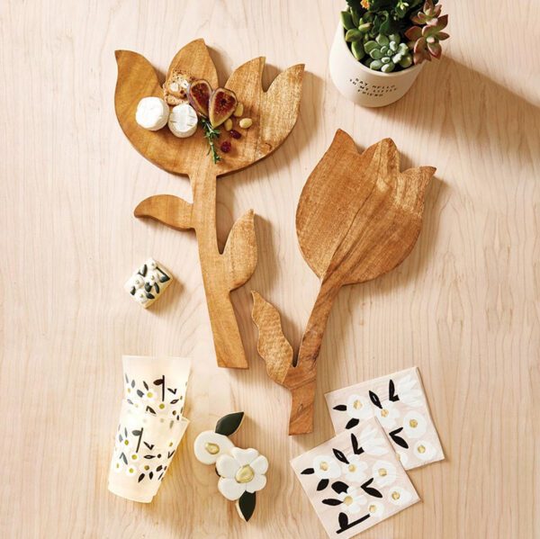 Handcrafted mango wood tulip-shaped cutting board with a single leaf detail, shown from a flat side angle