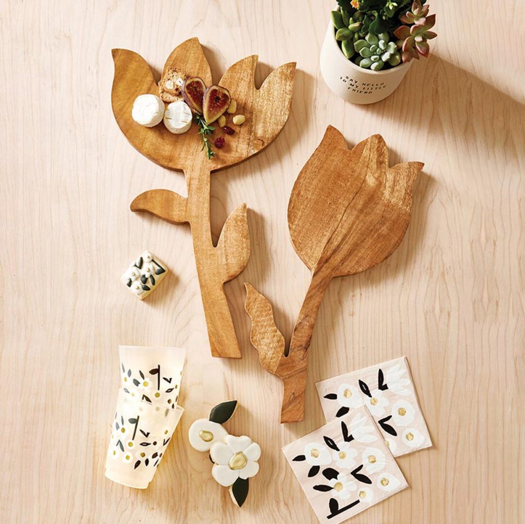 Handcrafted mango wood tulip-shaped cutting board with a single leaf detail, shown from a flat side angle